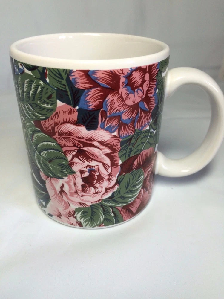 Floral coffee mug with pink mauve flowers and green leaves, white interior and handle