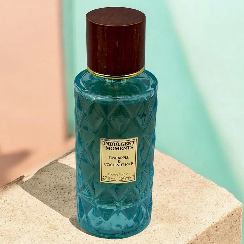 Turquoise eau de parfum bottle with gold cap, Pineapple & Coconut Milk label.