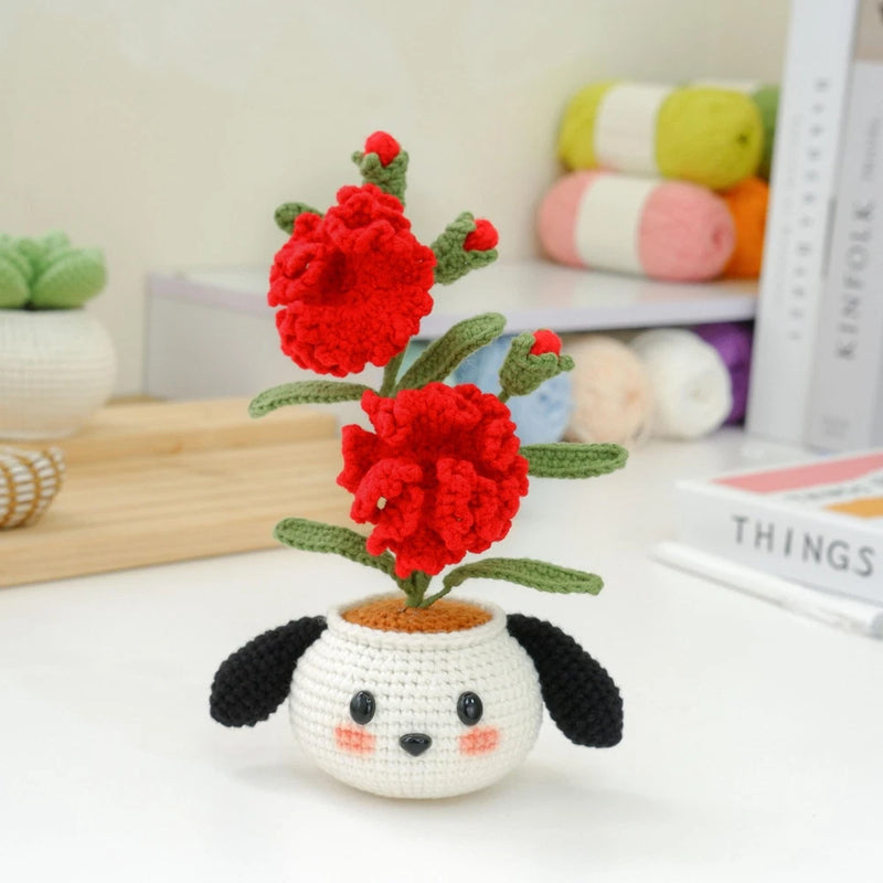Crochet puppy flower pot with red pom-pom flowers and white pot, black ears