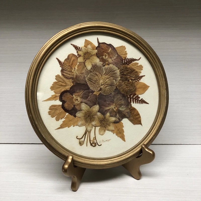 Oval gold wood framed pressed dried flower artwork with brown bouquet center