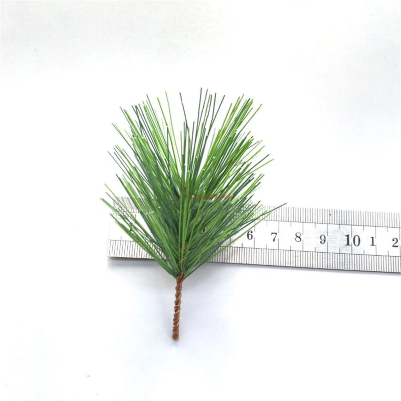 Artificial pine needle sprig, green tips on short stem, about 9 cm long