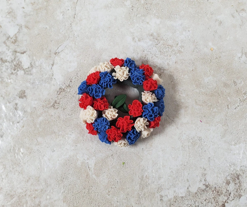 Miniature carnation wreath with red, white, and blue rosette flowers