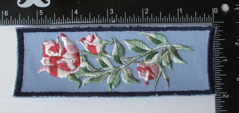 Embroidered rose cuff patch, light blue rectangle with red roses and green leaves