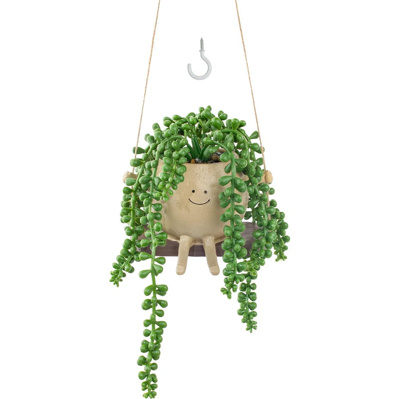 Hanging smiley swing planter with artificial green string-of-pearls succulent strands