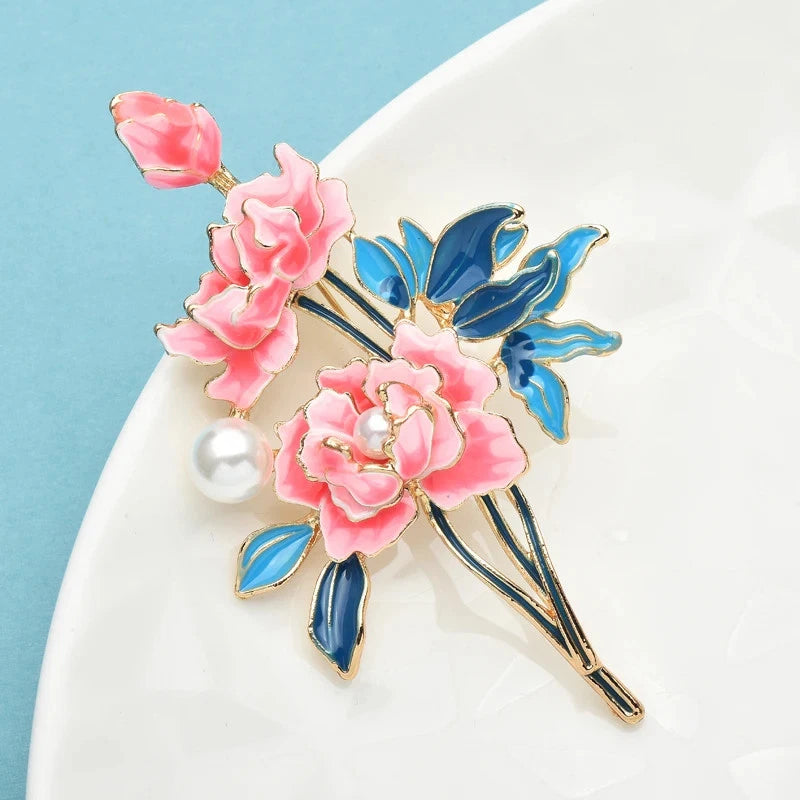 Enamel peony flower brooch pin with pink blooms, pearl bead, and blue leaf accents