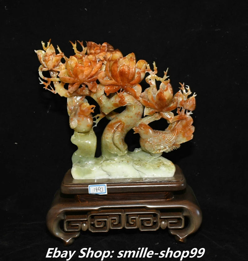Carved peony flower bird statue with orange blossoms, green base, on dark stand