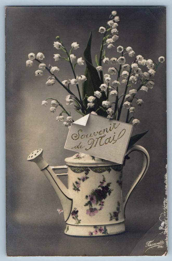 Vintage postcard of a floral watering can with lilies and greeting note