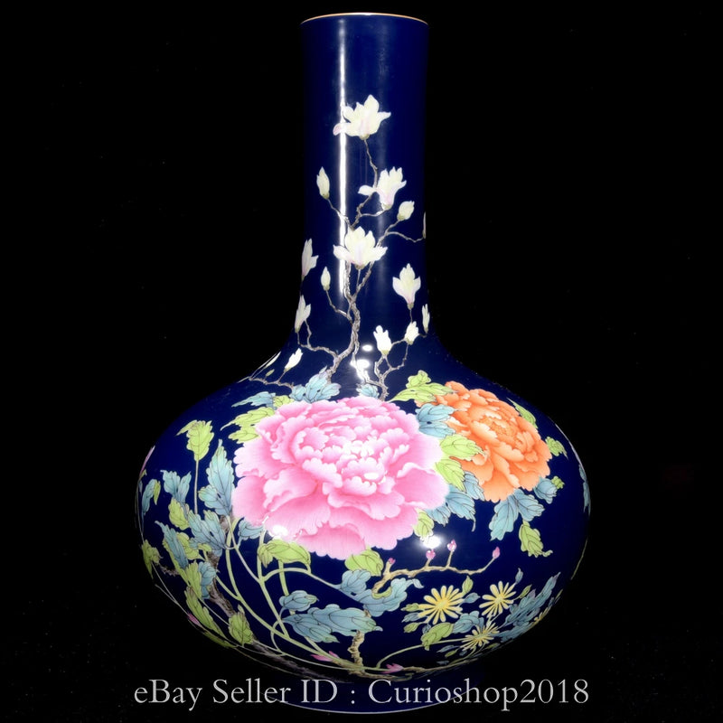 Blue porcelain bottle vase with peony floral design and pale blossoms on body