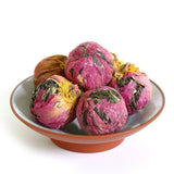 Raw puer tea tuo balls with dried peony flowers in a bowl