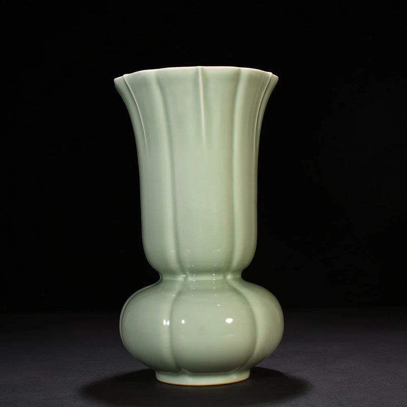 Light teal porcelain vase with fluted neck and bulbous base