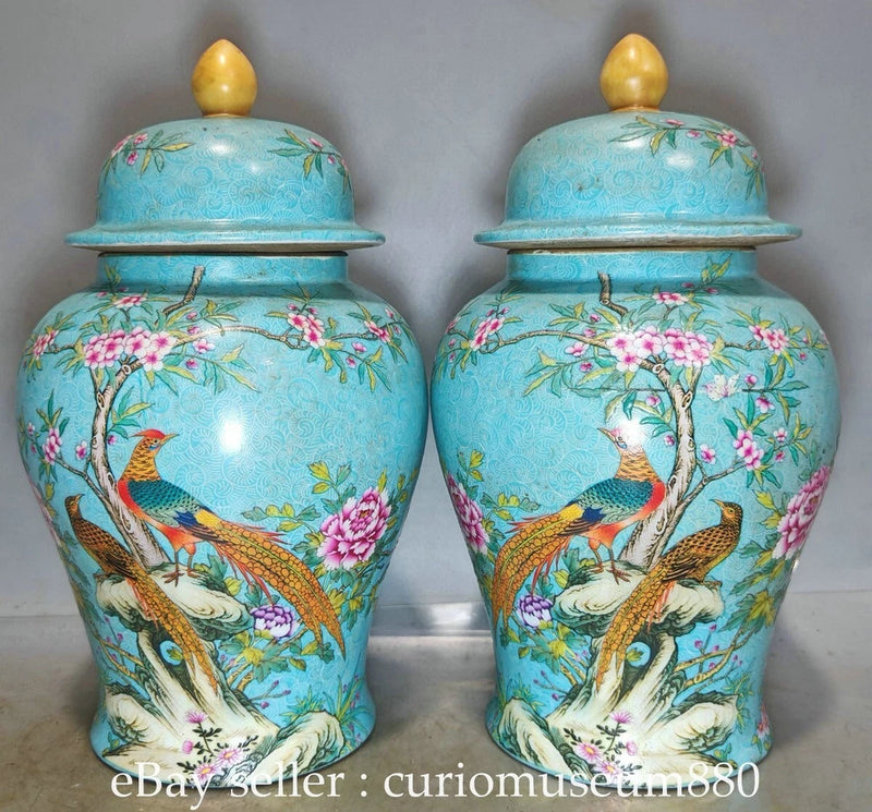 Pair of blue porcelain garden urns with lids, painted birds and peonies, Qianlong style