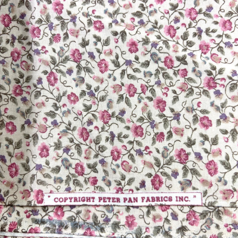 Ivory cotton calico fabric with tiny pink roses and purple flowers, Peter Pan copyright label