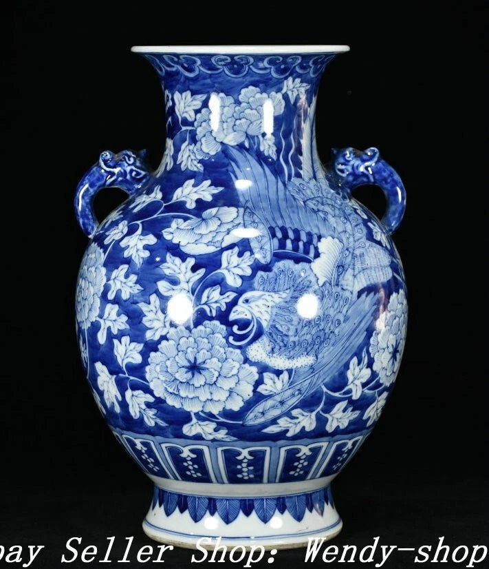 Blue and white porcelain vase with floral relief, flared rim, and curved side handles