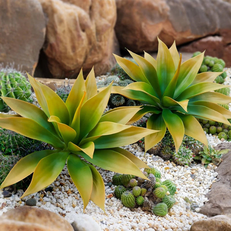 Large artificial agave plant arrangement with green and yellow spiky leaves in a stone planter