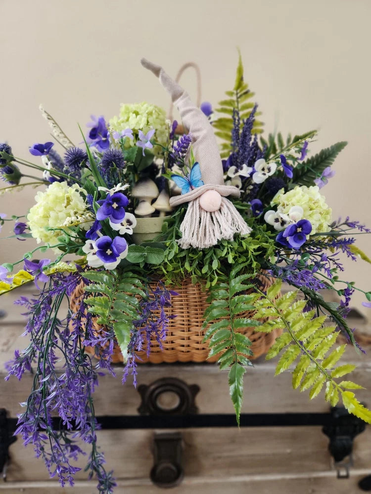 Garden gnome flower basket decoration with purple and white blooms and greenery