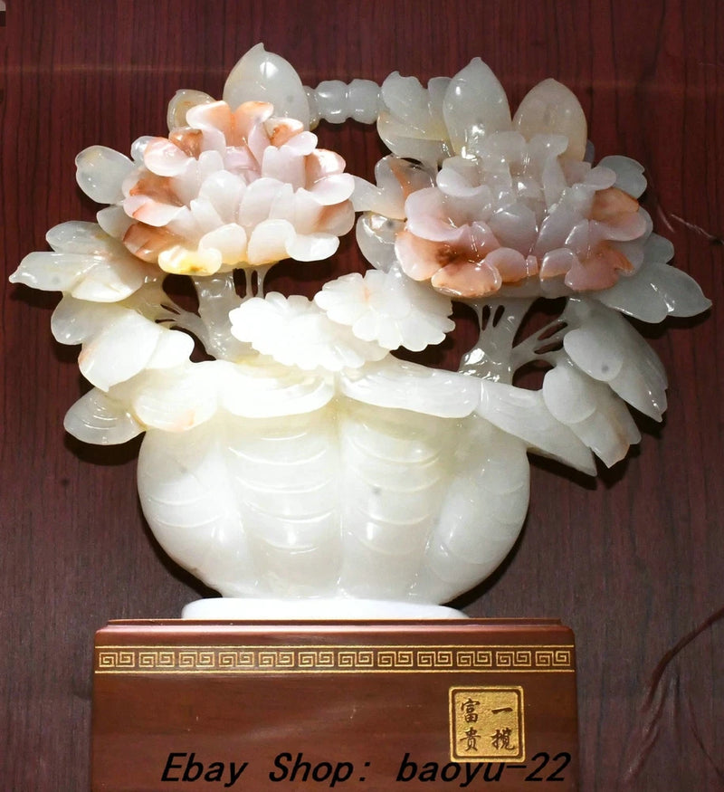 White jade peony flower carving in carved vase statue, hollow-out floral details.