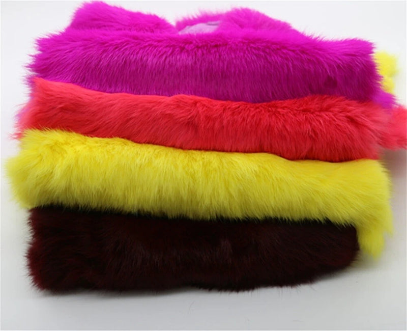 Dyed rabbit fur pelt hide with layered multicolor magenta, red, yellow, and dark brown fur