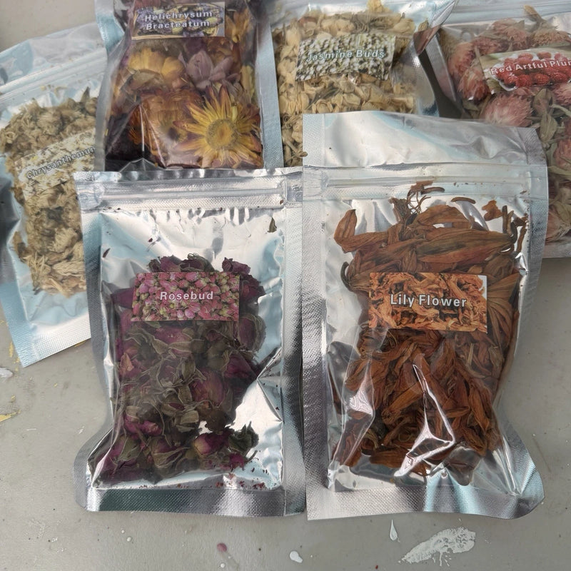 Assorted dried flower packs in sealed foil pouches with rosebud and lily flowers.