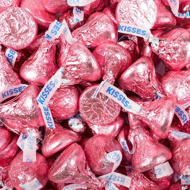 Milk chocolate heart candies with pink foil wrappers, KISSES labels