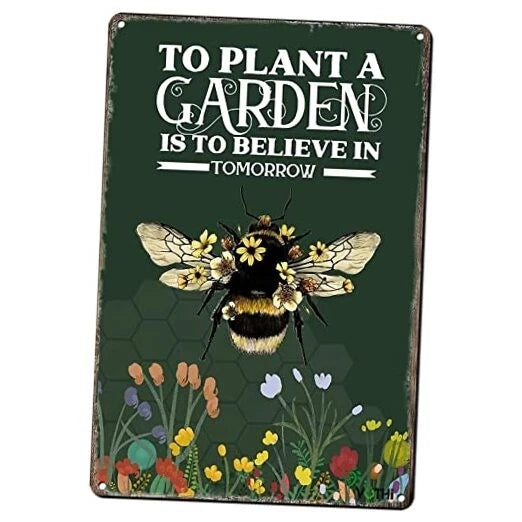 Green metal garden sign with bee, flowers, and 'TO PLANT A GARDEN' text