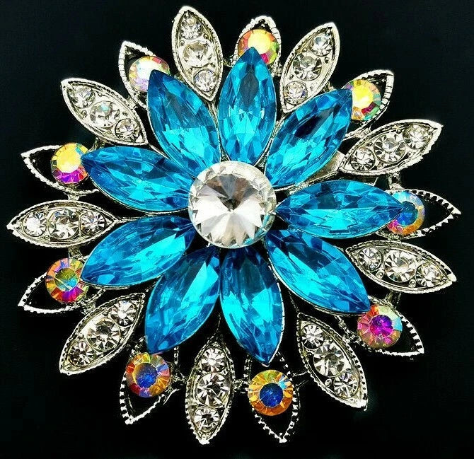 Rhinestone flower brooch with blue crystal petals and multicolor gem accents