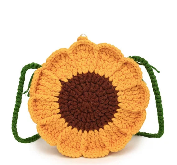Crochet sunflower purse with brown center and green handle ties