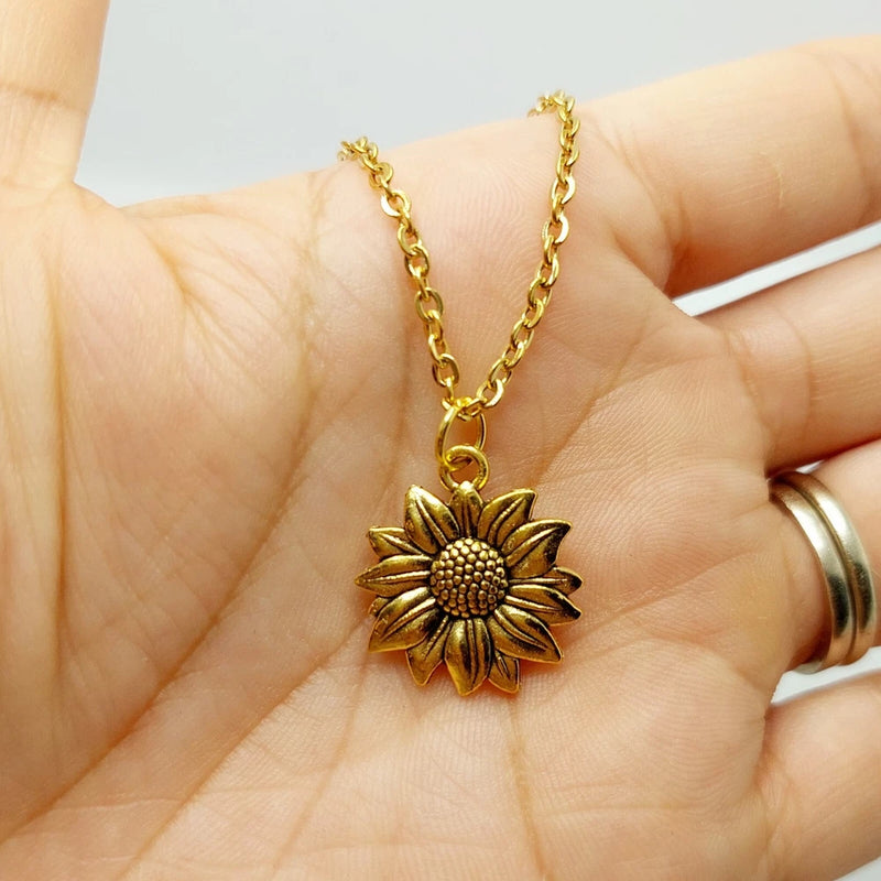 Sunflower charm necklace with gold-tone chain and round sunflower pendant
