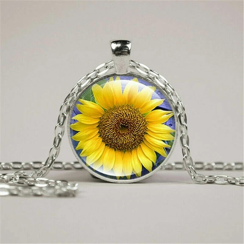 Round sunflower pendant necklace with yellow flower under clear glass, silver chain