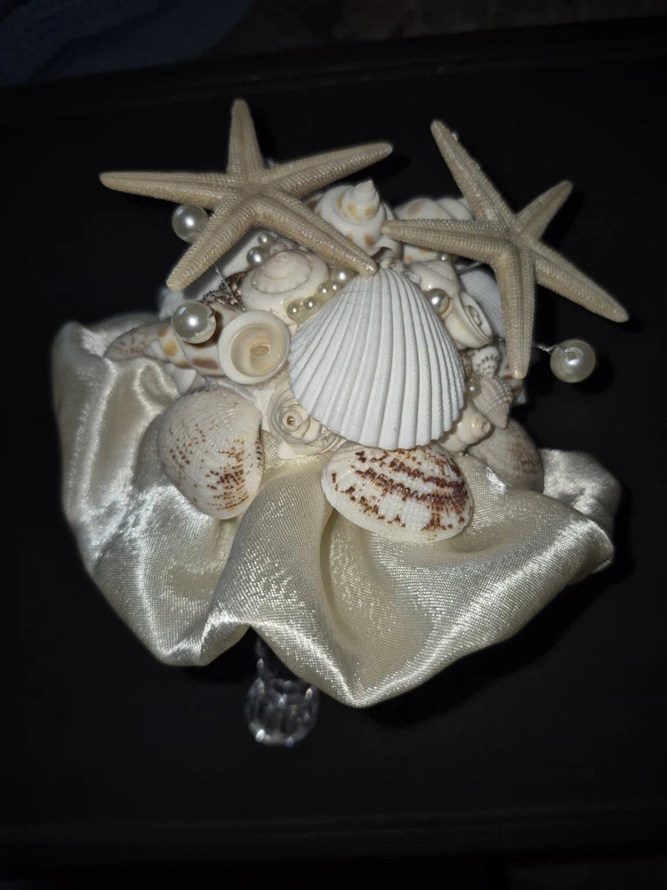 Seashell bouquet with starfish, pearls, and seashells on shiny satin ribbon
