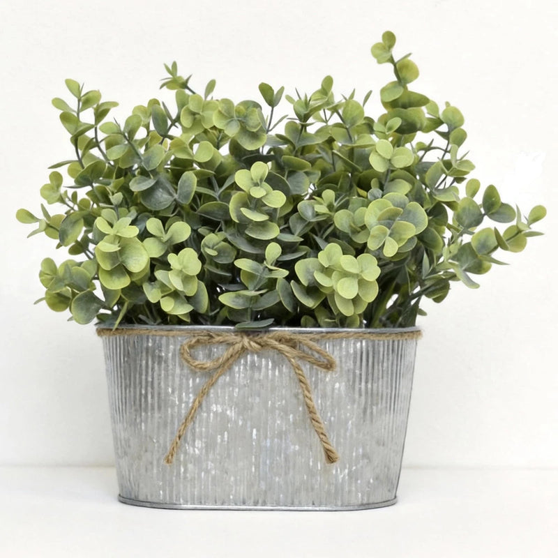 Artificial eucalyptus faux plant in silver metal bucket with twine bow and green leaves