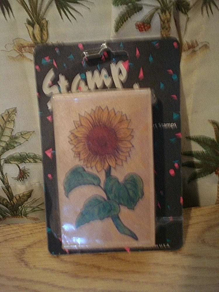 Wood-mounted rubber stamp with sunflower design in clear packaging
