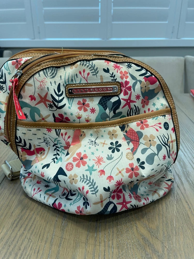 Mermaid print backpack with front zip pocket, top handle, and multicolor fabric design