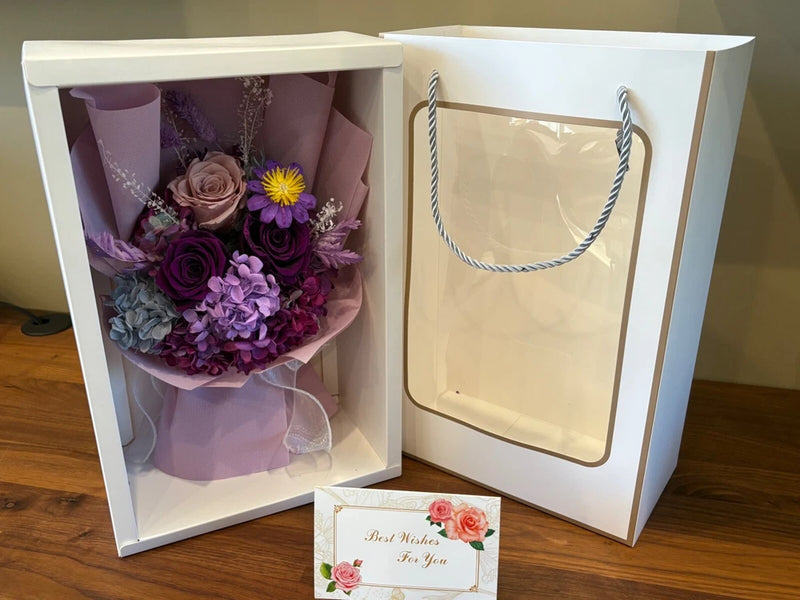 Preserved rose and mixed flower bouquet in gift box, purple blooms in tissue
