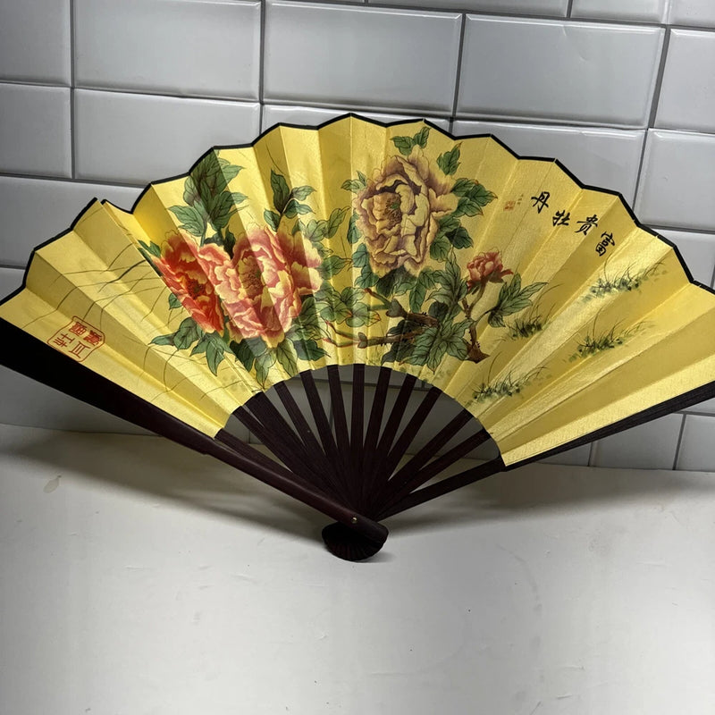 Yellow folding hand fan with peony flowers and bamboo frame