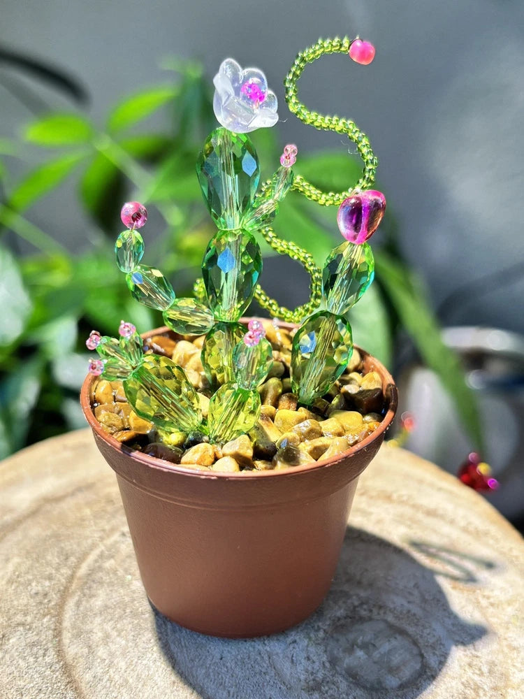 Green glass cactus plant ornament with pink bead flowers, in terracotta pot