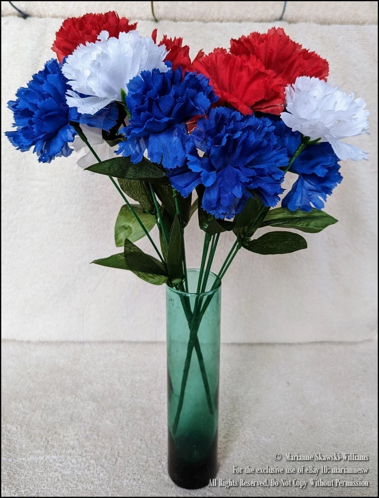 Patriotic carnation flower bouquet with red, white, and blue blooms and green leaves