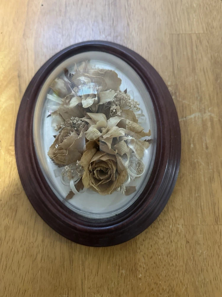Oval dark brown framed dried wedding bouquet with beige, cream and tan flowers