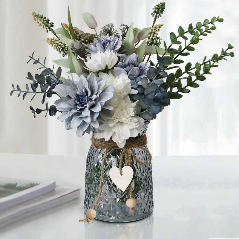 Faux flower vase centerpiece with blue and white blooms and heart ornament