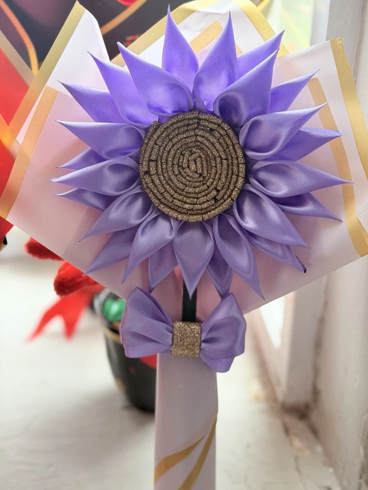 Purple fabric sunflower wall decor with layered petals, beige ribbons, and dark spiral center