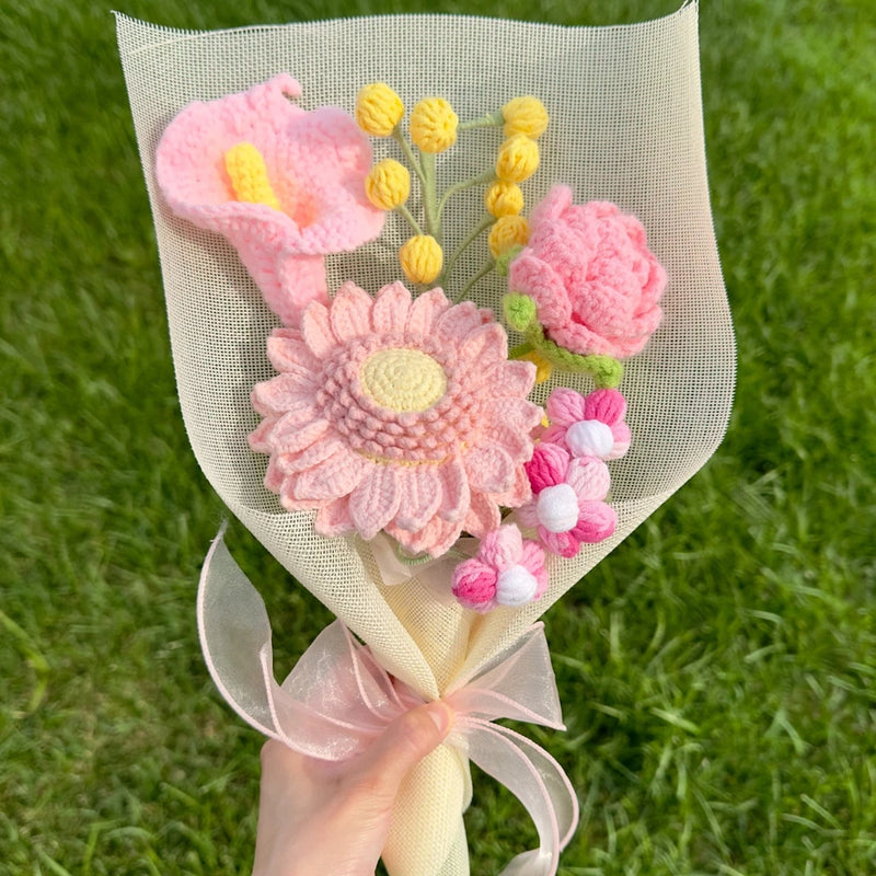 Crochet flower bouquet with pink and yellow tulip, rose, and sunflower flowers, wrapped.