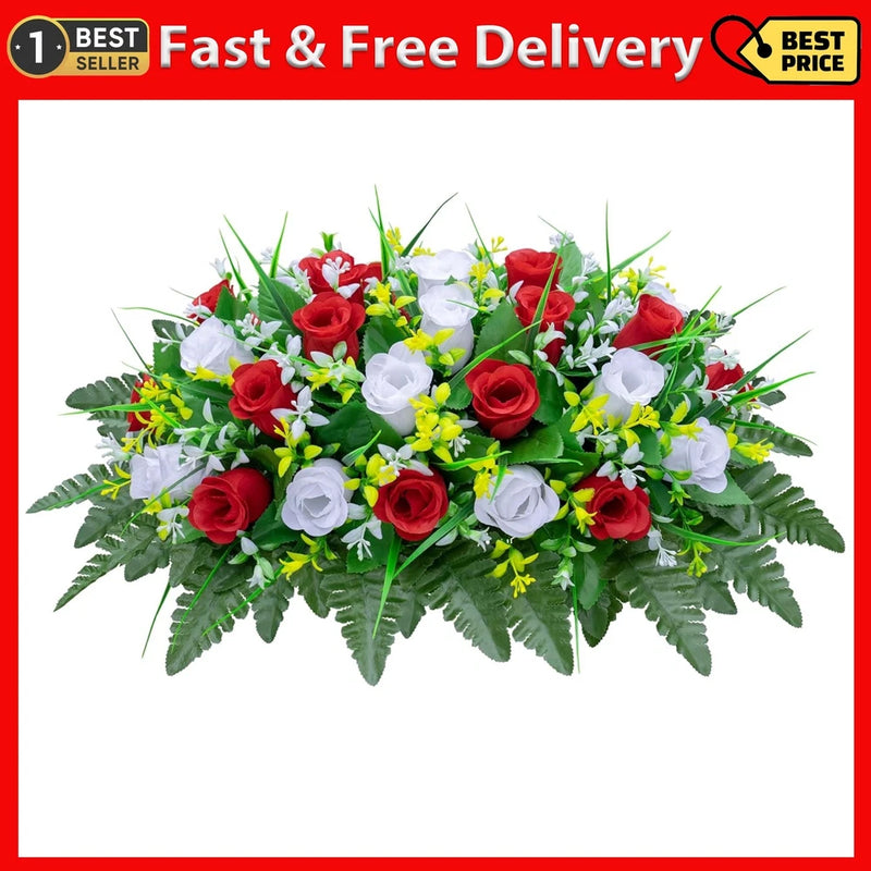 Saddle-shaped grave flower arrangement with red roses, white blossoms, and green leaves