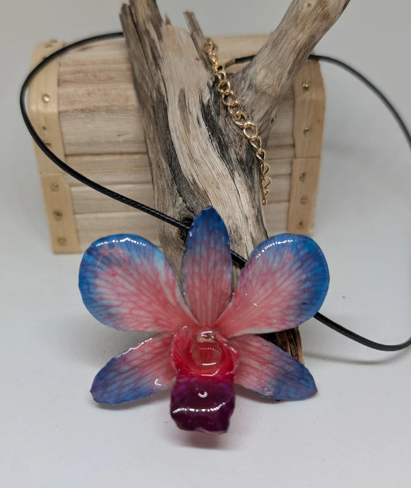 Resin orchid pendant necklace with black faux leather cord, blue-pink flower