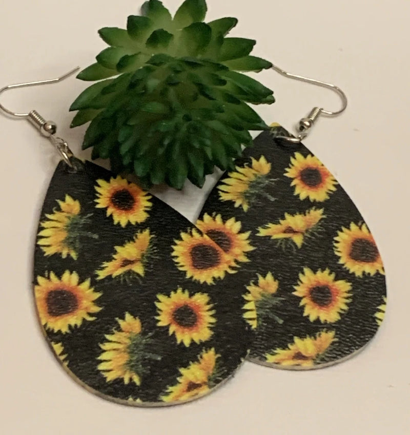 Sunflower print drop earrings with green leaf-shaped top and metal hooks