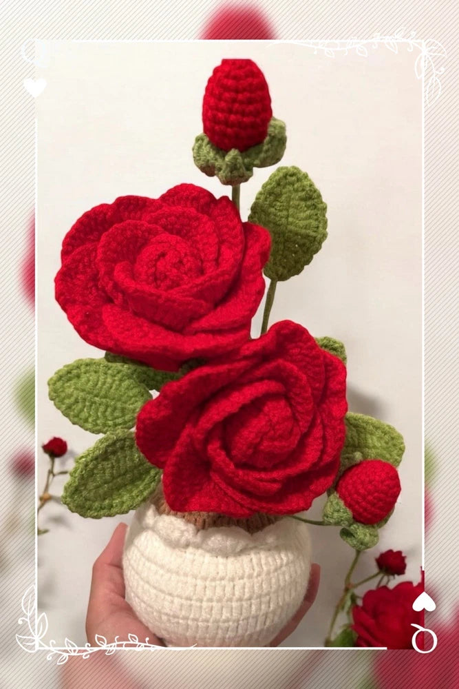 Handmade crochet rose bouquet in white pot with red blooms, green leaves, red buds