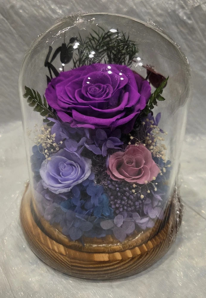 Glass dome preserved flowers with purple rose and mixed lavender and pink roses