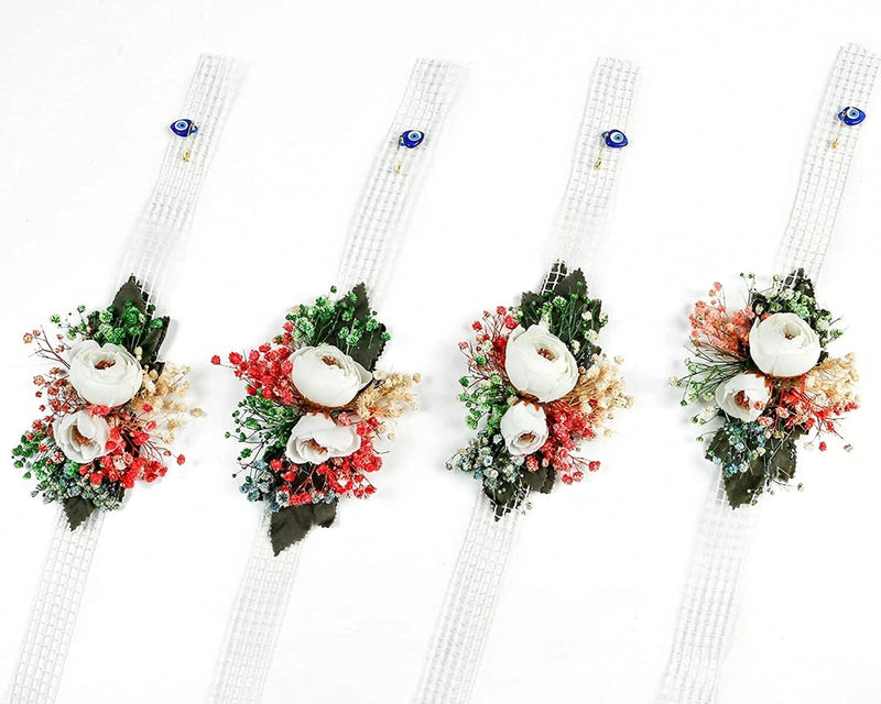 Set of 4 white floral wrist corsages with ribbon straps, roses, greenery, and red accents
