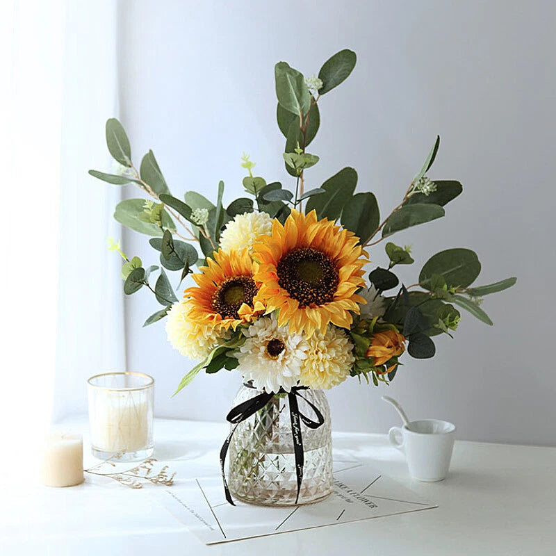 Silk sunflower bouquet in clear glass vase with yellow, orange, and white blooms