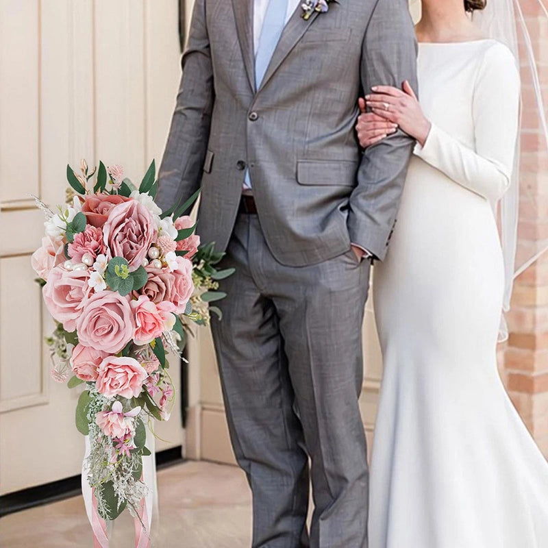 Cascading bridal bouquet with pink roses, greenery, and ribbon streamers