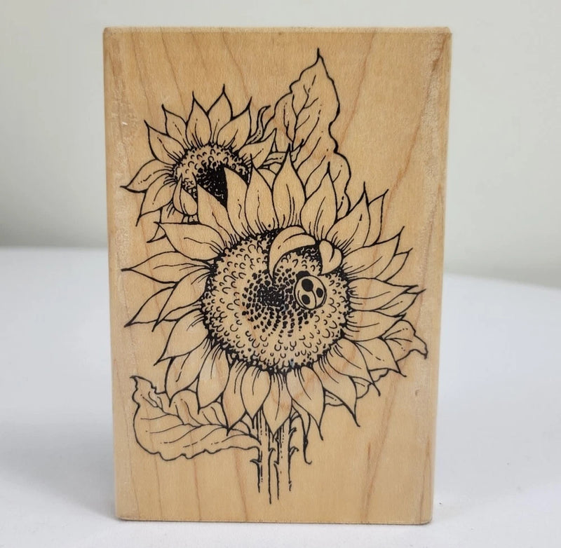 Wood mounted sunflower and ladybug stamp block with black line-art floral design