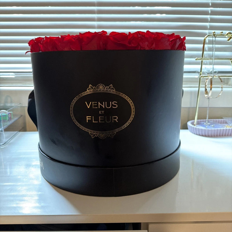 Large black flower box with red rose arrangement and Venus et Fleur gold logo